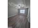 Spacious bedroom with tray ceiling, ceiling fan and window with blinds and laminate floors at 1105 Bradford Park Dr, Auburn, GA 30011