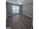 Spacious bedroom with ceiling fan, and large window with blinds and laminate floors at 1105 Bradford Park Dr, Auburn, GA 30011