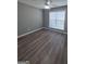 Bedroom featuring ceiling fan, window with blinds and laminate floor at 1105 Bradford Park Dr, Auburn, GA 30011