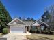 Charming single-story home with a two-car garage and well-maintained landscaping at 1105 Bradford Park Dr, Auburn, GA 30011