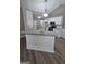 Open-concept kitchen with island, granite countertops, and modern pendant lighting at 1105 Bradford Park Dr, Auburn, GA 30011