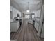 Open kitchen and dining area with stainless steel appliances and modern finishes at 1105 Bradford Park Dr, Auburn, GA 30011