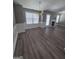 Spacious living room with fireplace, large windows, and modern flooring at 1105 Bradford Park Dr, Auburn, GA 30011