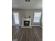 Cozy living room featuring a fireplace, modern flooring, and natural light at 1105 Bradford Park Dr, Auburn, GA 30011