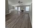 Open-concept living room with fireplace, plenty of natural light, and modern flooring at 1105 Bradford Park Dr, Auburn, GA 30011