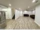 Spacious finished basement featuring modern flooring, recessed lighting, and comfortable seating area at 1521 Ashbury Park Dr, Hoschton, GA 30548