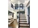 Bright foyer featuring hardwood floors, a staircase with iron railings, and an upper level balcony at 1521 Ashbury Park Dr, Hoschton, GA 30548
