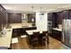 Well-equipped kitchen with dark wood cabinets, granite countertops, and stainless steel appliances at 1521 Ashbury Park Dr, Hoschton, GA 30548