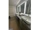 Elegant bathroom featuring double sinks, granite countertops, and modern fixtures at 11523 Kimberly Way # 6, Hampton, GA 30228