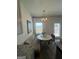 Bright dining area with a unique bench seating arrangement and stylish chandelier at 11523 Kimberly Way # 6, Hampton, GA 30228