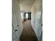 Inviting hallway leading into a brightly lit living room with neutral decor at 11523 Kimberly Way # 6, Hampton, GA 30228