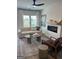 Bright living room featuring a ceiling fan, fireplace, plush seating, creating an inviting and comfortable ambiance at 11523 Kimberly Way # 6, Hampton, GA 30228