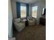 Cozy living room featuring two comfortable armchairs and natural light at 11523 Kimberly Way # 6, Hampton, GA 30228