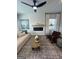 Well-lit living room boasts a modern ceiling fan, fireplace with wooden mantel, and elegant furnishings at 11523 Kimberly Way # 6, Hampton, GA 30228