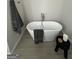 Contemporary bathroom showcases a freestanding tub with modern fixtures and tiled floor at 11551 Kimberly Way # 17, Hampton, GA 30228