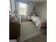 Comfortable bedroom featuring neutral paint, dresser, patterned rug, and window view at 11551 Kimberly Way # 17, Hampton, GA 30228