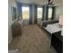 This large bedroom offers three large windows, a ceiling fan, and a modern dresser at 11551 Kimberly Way # 17, Hampton, GA 30228