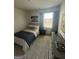 Bedroom featuring bright window, baseball themed art, striped rug, and dresser at 11551 Kimberly Way # 17, Hampton, GA 30228