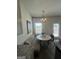 Dining area with built-in seating, round table, and decorative lighting at 11551 Kimberly Way # 17, Hampton, GA 30228