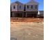 New townhome construction featuring gray siding and a drive-under garage at 11551 Kimberly Way # 17, Hampton, GA 30228