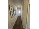 Entry hallway with wood-look flooring, neutral walls and decorative art pieces at 11551 Kimberly Way # 17, Hampton, GA 30228