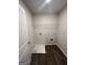 Efficient laundry room with hookups and wire shelving for storage at 11551 Kimberly Way # 17, Hampton, GA 30228