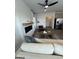 Inviting living room with fireplace, ceiling fan, and view into the kitchen with stainless steel refrigerator at 11551 Kimberly Way # 17, Hampton, GA 30228