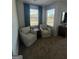 Comfortable sitting room with two chairs and a small table, perfect for relaxing and reading at 11551 Kimberly Way # 17, Hampton, GA 30228