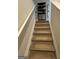Carpeted stairway with white railing leading to the upper level of the home at 11551 Kimberly Way # 17, Hampton, GA 30228