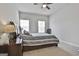 Bedroom with a ceiling fan, a big bed, and two windows providing ample natural light at 130 Brooks Cir, Hampton, GA 30228