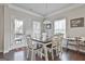 Bright dining room featuring a dark wood table with white chairs and access to a deck at 130 Brooks Cir, Hampton, GA 30228