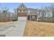 Beautiful two-story home with a brick and siding exterior and attached two car garage at 130 Brooks Cir, Hampton, GA 30228