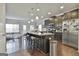 Modern kitchen featuring a large island, stainless steel appliances, and dark wood cabinetry at 130 Brooks Cir, Hampton, GA 30228