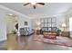 Spacious living room features dark wood floors and multiple seating areas at 130 Brooks Cir, Hampton, GA 30228