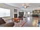 Open living space with fireplace, dark hardwood floors, and a combined kitchen and dining area at 130 Brooks Cir, Hampton, GA 30228