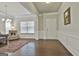Elegant living room boasts hardwood floors, chair railing, and ample natural light at 130 Brooks Cir, Hampton, GA 30228
