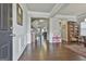 Spacious living room features hardwood floors, wainscoting, and views into the kitchen at 130 Brooks Cir, Hampton, GA 30228