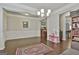 Spacious living room features hardwood floors, elegant lighting, and views into the kitchen at 130 Brooks Cir, Hampton, GA 30228