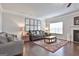 Comfortable living room featuring hardwood floors, neutral tones, and a cozy fireplace at 130 Brooks Cir, Hampton, GA 30228