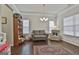 Comfortable living room featuring a neutral-colored sofa, hardwood flooring, and natural light from the window at 130 Brooks Cir, Hampton, GA 30228