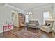 Cozy living room featuring a neutral-colored sofa, hardwood flooring, and a playful area at 130 Brooks Cir, Hampton, GA 30228