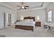 Spacious main bedroom featuring a ceiling fan and a well-coordinated furniture set, creating a relaxing retreat at 130 Brooks Cir, Hampton, GA 30228
