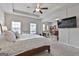 Generously sized main bedroom includes a bed, a ceiling fan, and a dedicated workspace, enhancing comfort at 130 Brooks Cir, Hampton, GA 30228