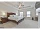 Bright main bedroom featuring a ceiling fan, tray ceiling, and lots of natural light at 130 Brooks Cir, Hampton, GA 30228