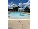 A community pool featuring a splash fountain and lounge chairs under a blue sky at 130 Brooks Cir, Hampton, GA 30228