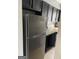 Kitchen with stainless steel refrigerator, dark cabinets, and granite countertops at 4477 Golf Vista Cir, Decatur, GA 30035