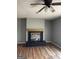 Living room featuring a fireplace with a black mantel, wood floors, and gray walls at 4477 Golf Vista Cir, Decatur, GA 30035