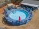 Aerial view showcases a beautiful, enclosed blue pool, deck, and the inviting backyard setup at 31 Pecan Lake Ct, Sharpsburg, GA 30277