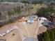 Wide aerial view of a home with a well-maintained yard, pool, detached garage, and surrounding neighborhood at 31 Pecan Lake Ct, Sharpsburg, GA 30277