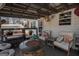 Charming back porch with seating area, fire pit and welcome sign at 31 Pecan Lake Ct, Sharpsburg, GA 30277